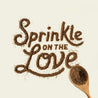 A wooden spoon sprinkling Missing Link powerful powder spelling out the words "Sprinkle on the Love"