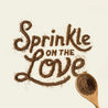 Wooden spoon sprinkling The Missing Link supplement onto a background to spell out "Sprinkle on the Love".